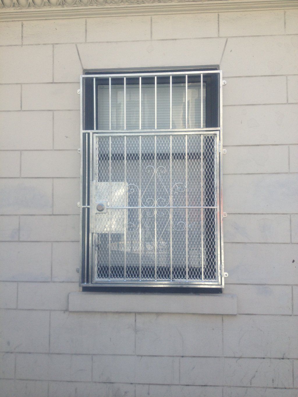 A brick wall with a window with bars on it