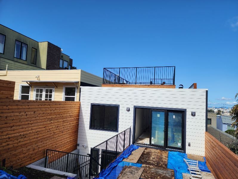 A white house with a balcony on top of it