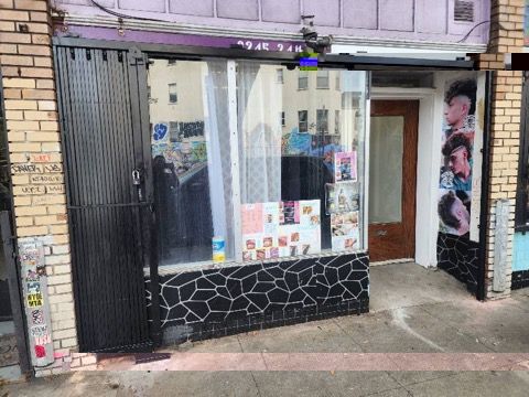 A brick building with a glass door and a sliding glass door.