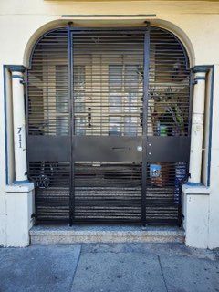 A black gate is sitting in front of a building.