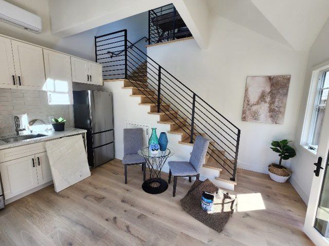A kitchen with stairs leading up to the second floor