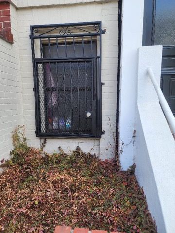 There is a window with a wrought iron gate on it.