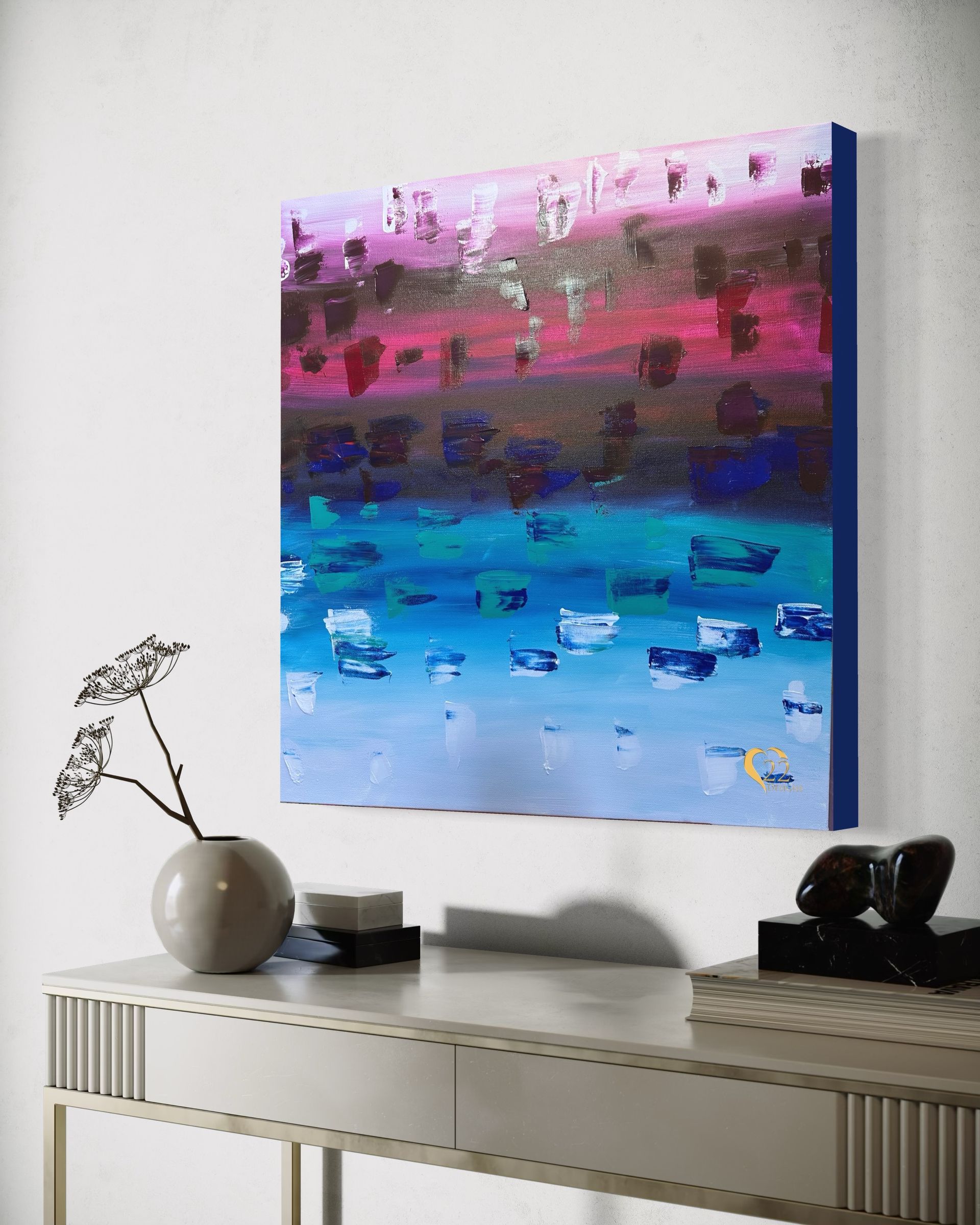 A painting is hanging on a wall above a table