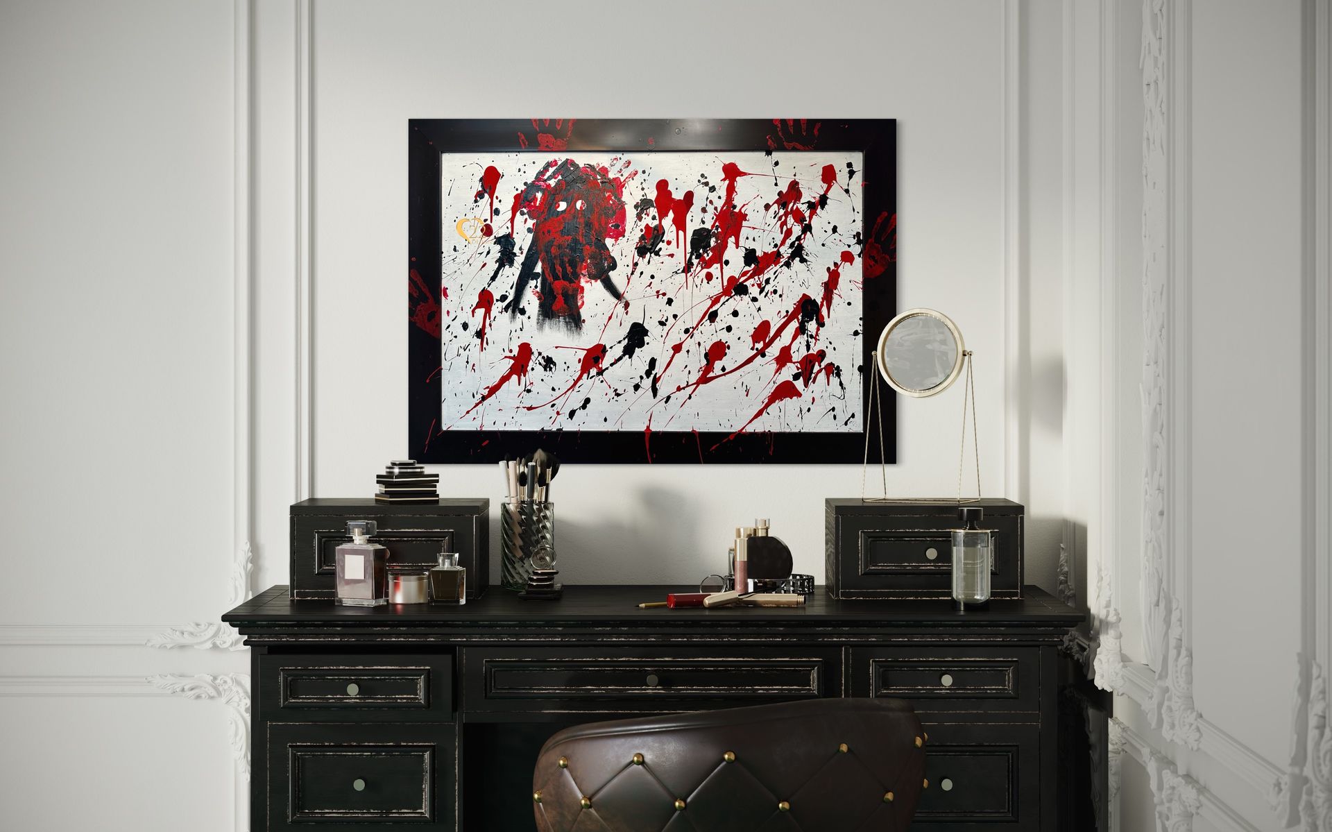 A black desk with a painting on the wall above it.