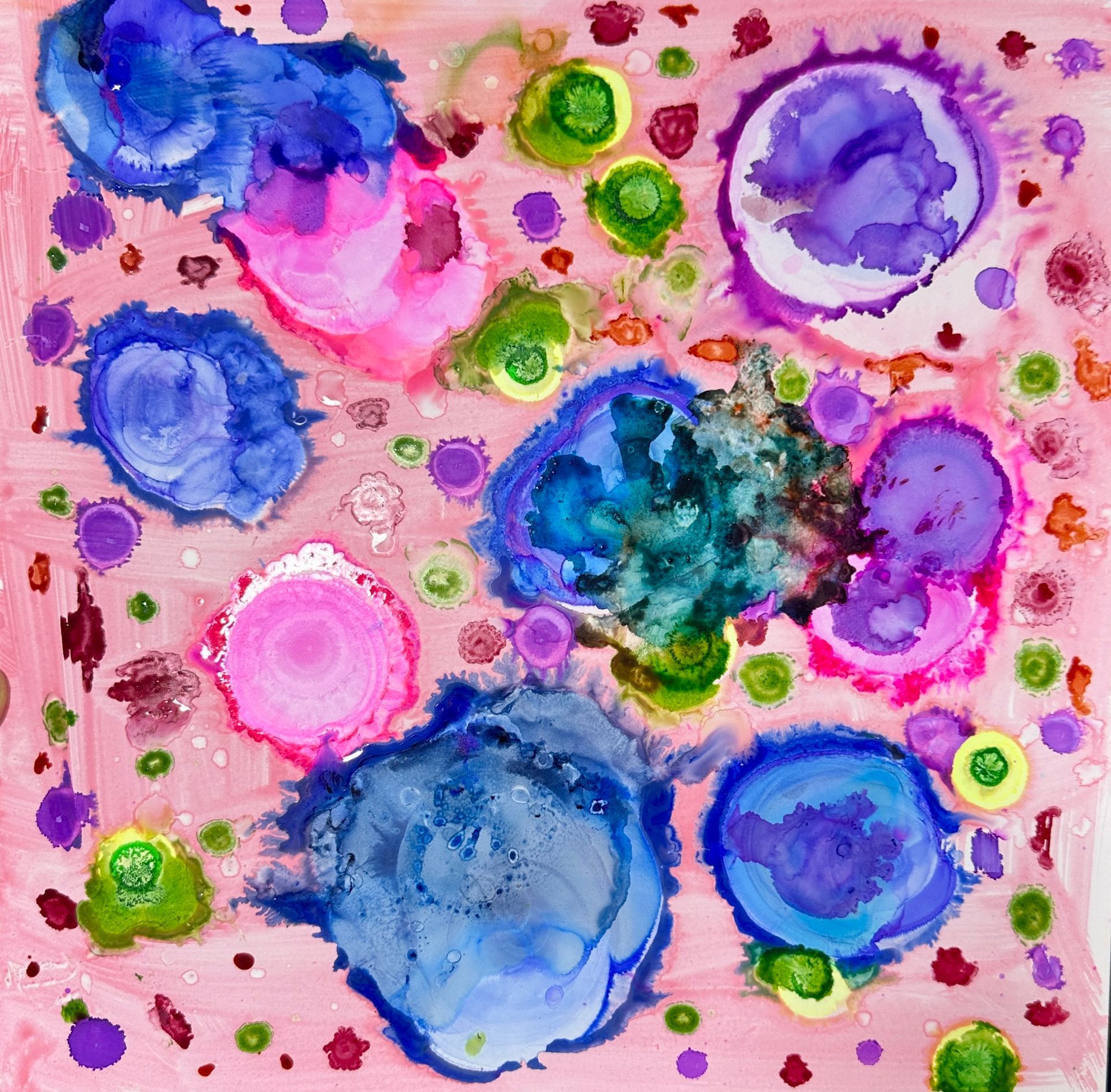A colorful painting of circles on a pink background