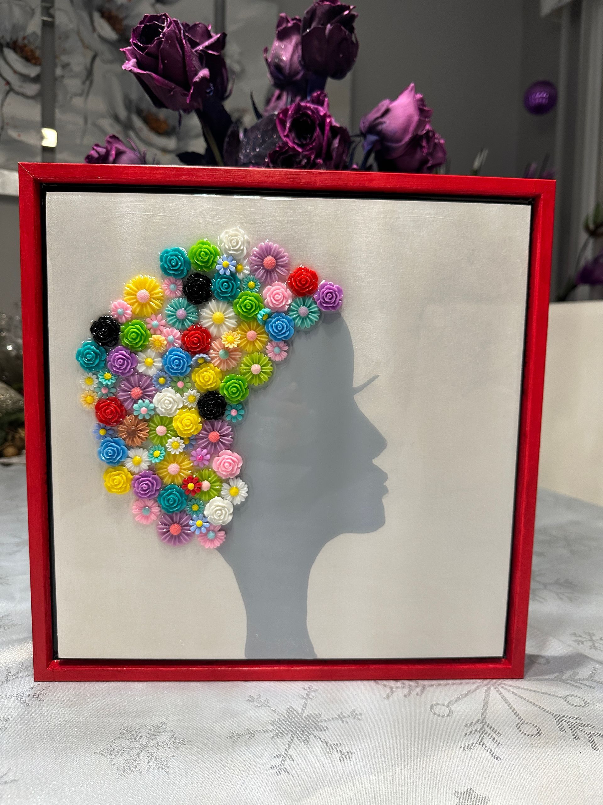 A painting of a woman 's head with flowers on it