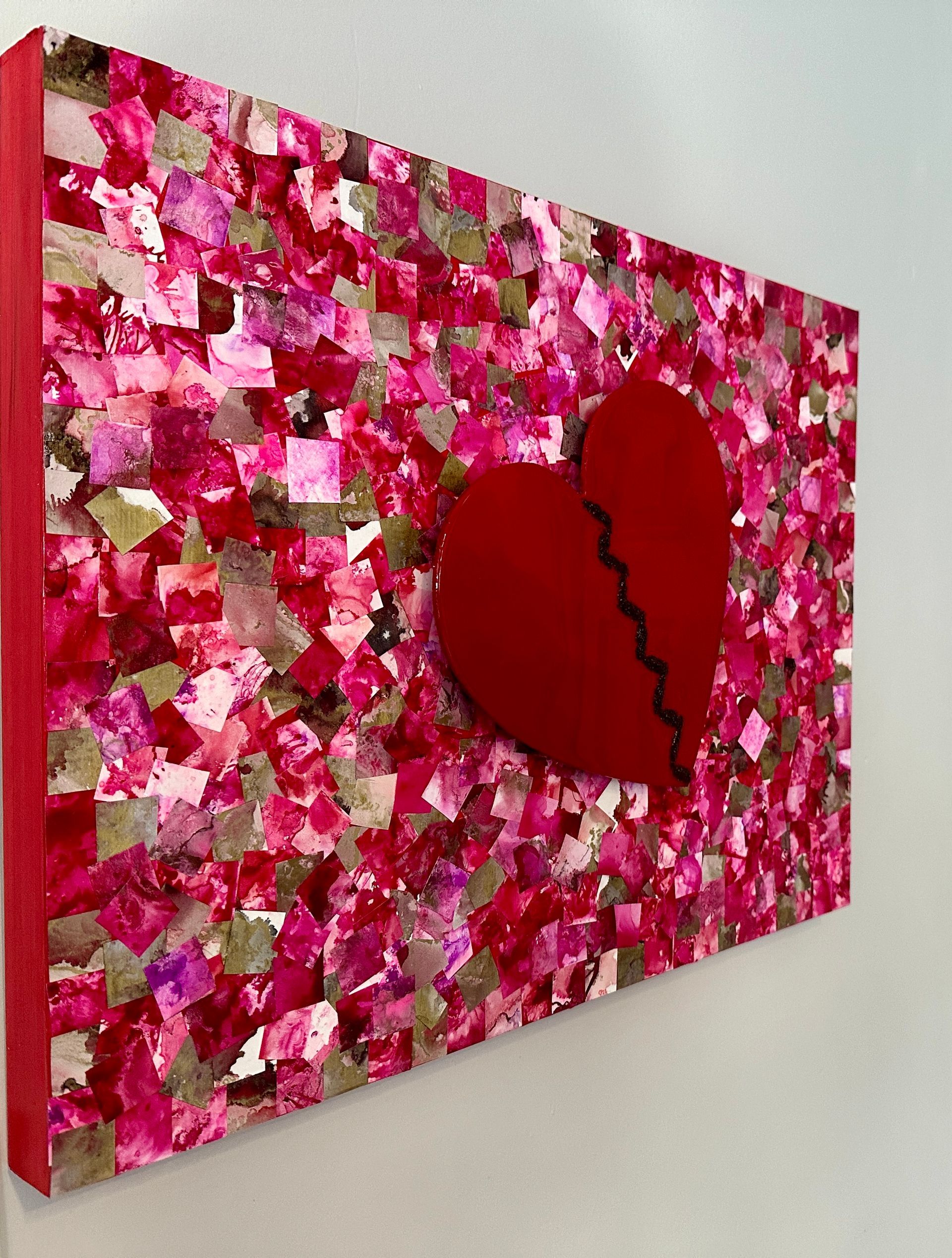 A painting of a broken heart on a pink background