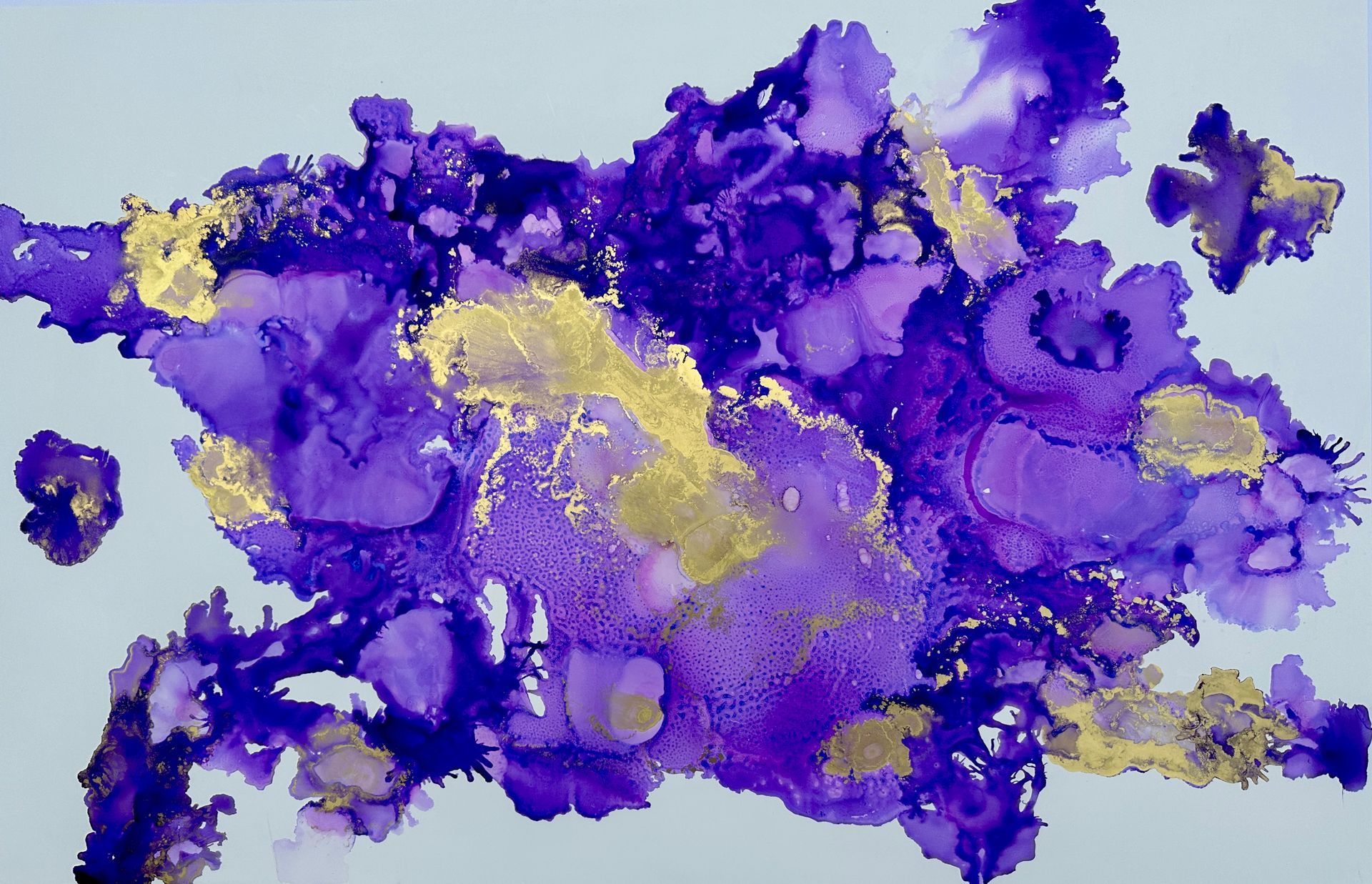 A close up of a purple and gold painting on a white background.