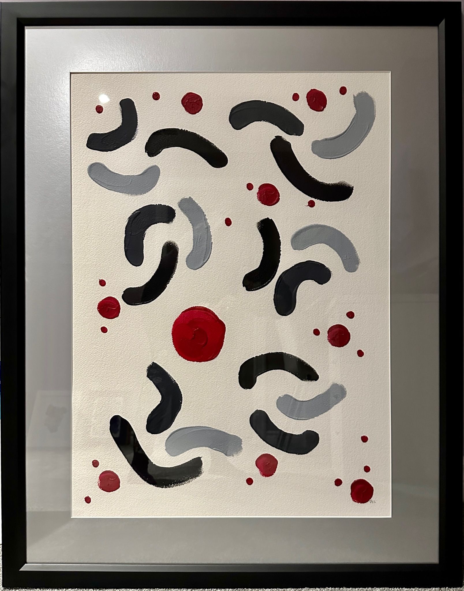 A black and white painting with a red circle in the middle