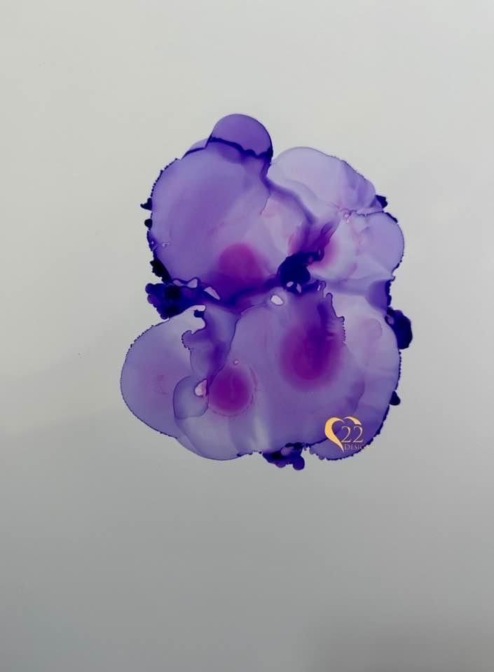 A close up of a purple flower on a white background