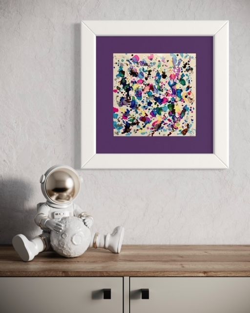 An astronaut sitting on a table next to a painting