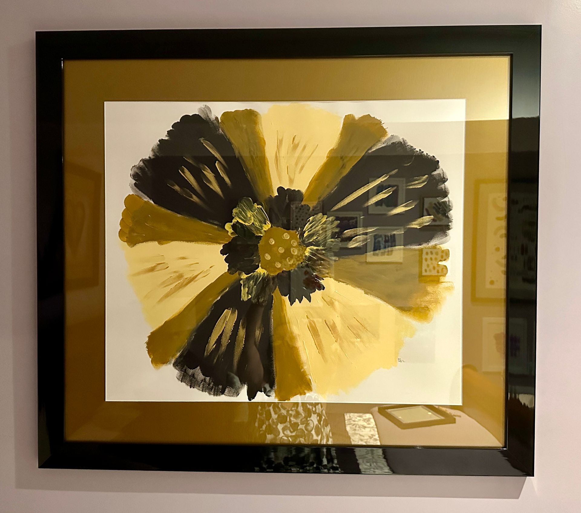 A framed picture of a yellow and black flower