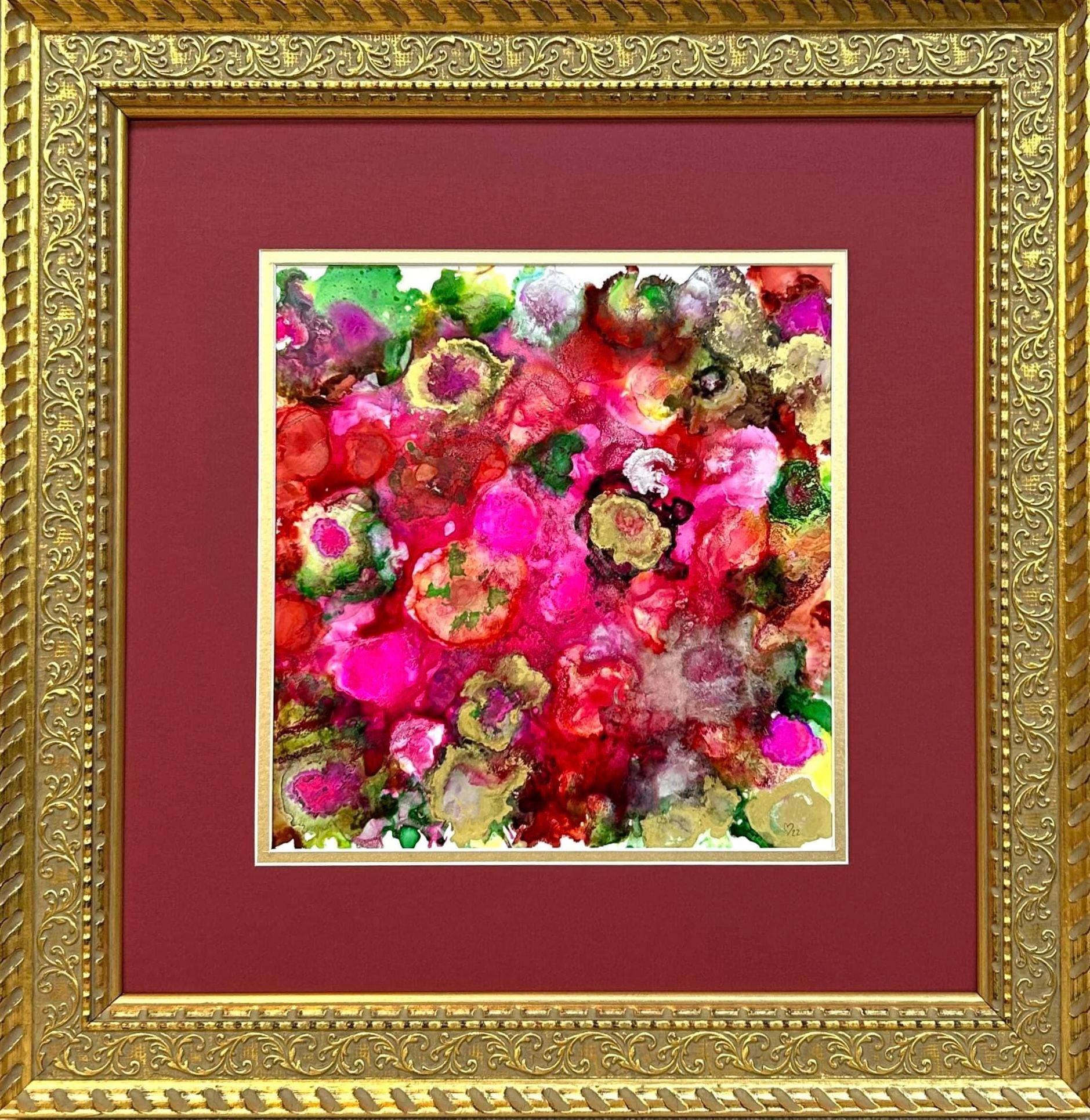 A picture of flowers in a gold frame