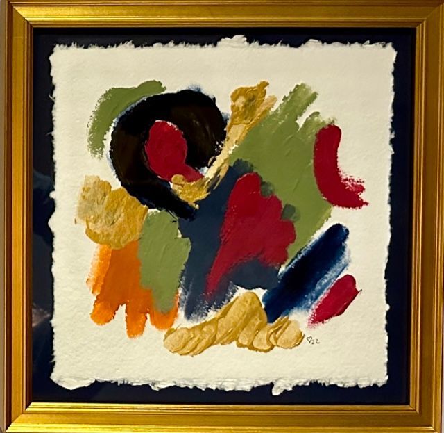 A colorful abstract painting in a gold frame