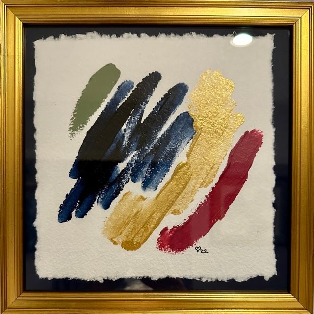 A framed painting of brush strokes of different colors