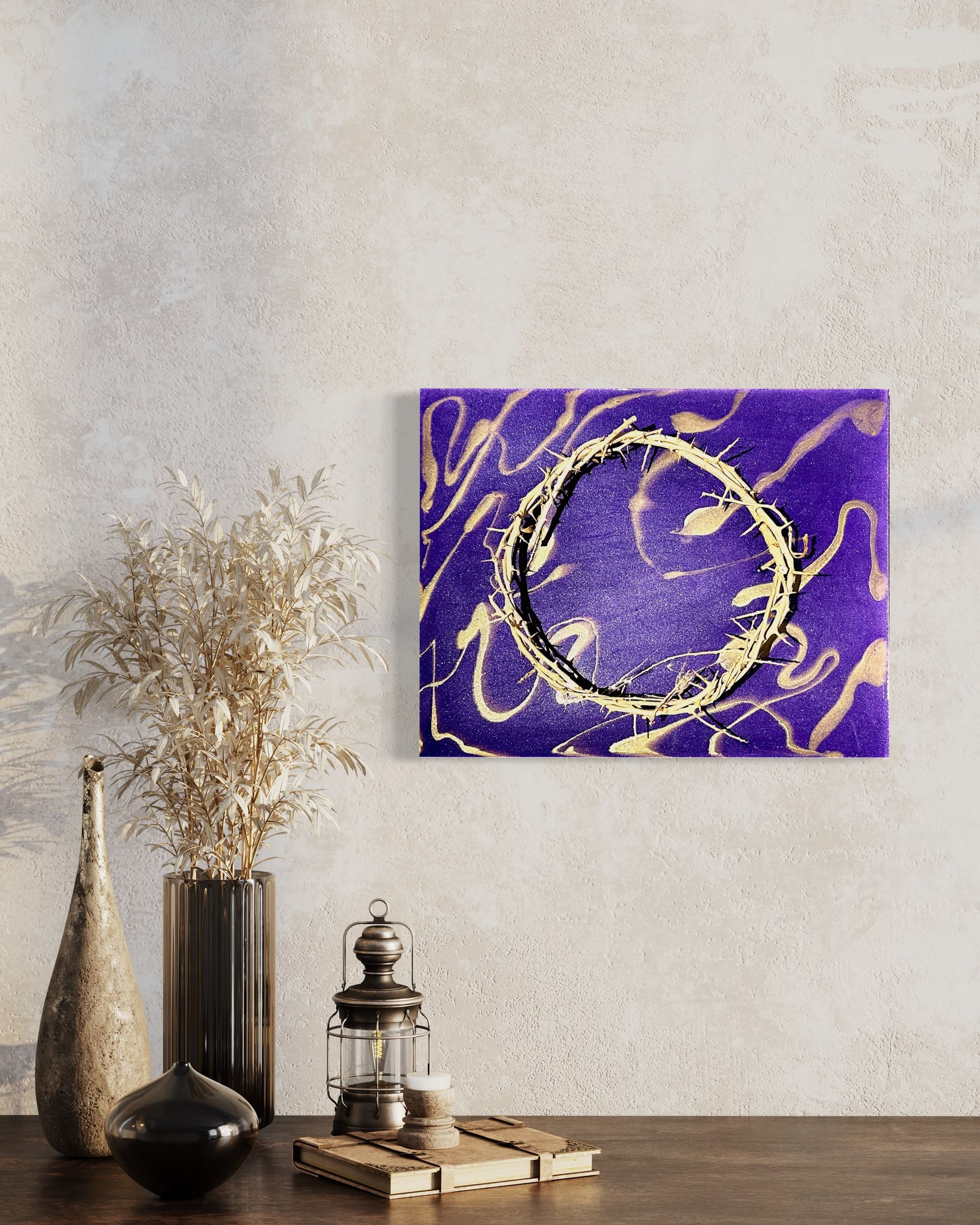 A purple and gold painting is hanging on a wall above a wooden table.
