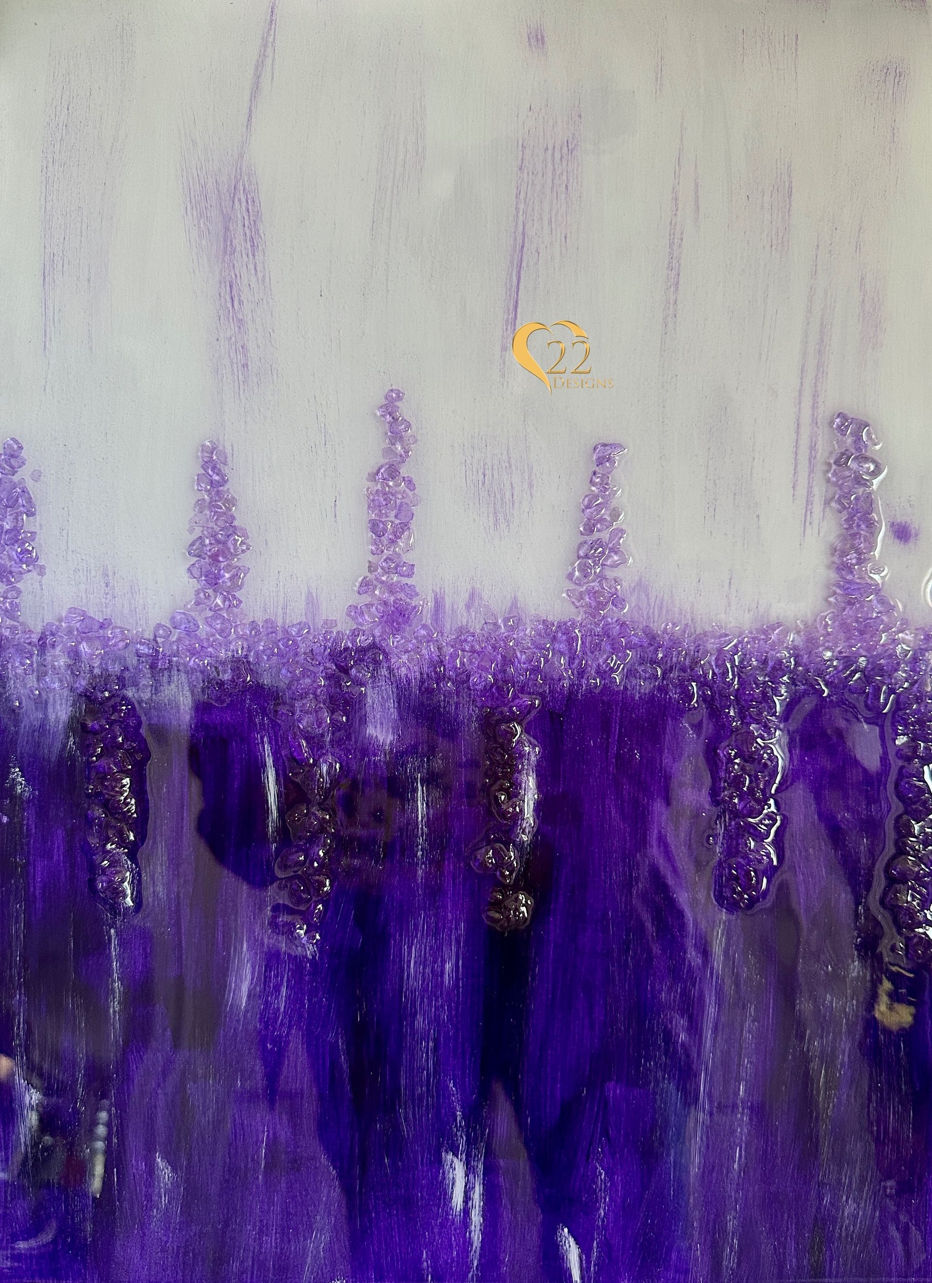 A close up of a purple and white painting on a wall.