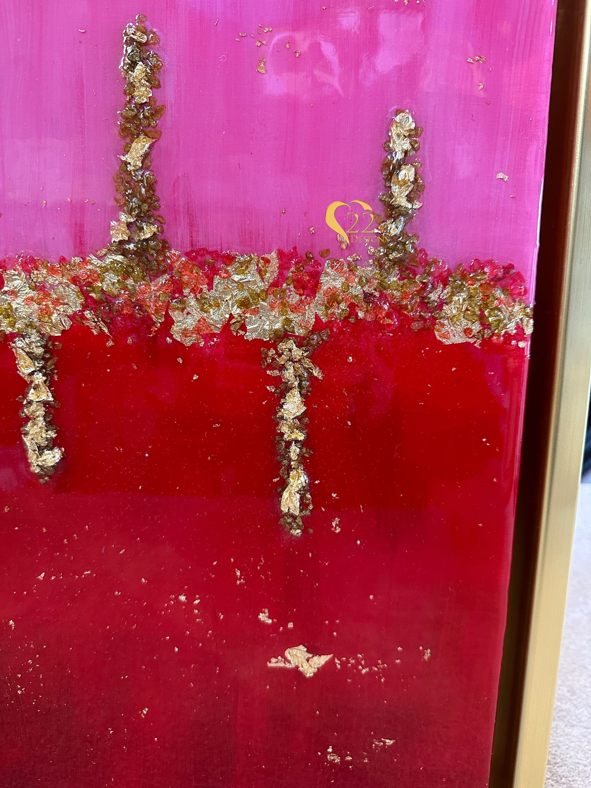 A close up of a red and gold painting