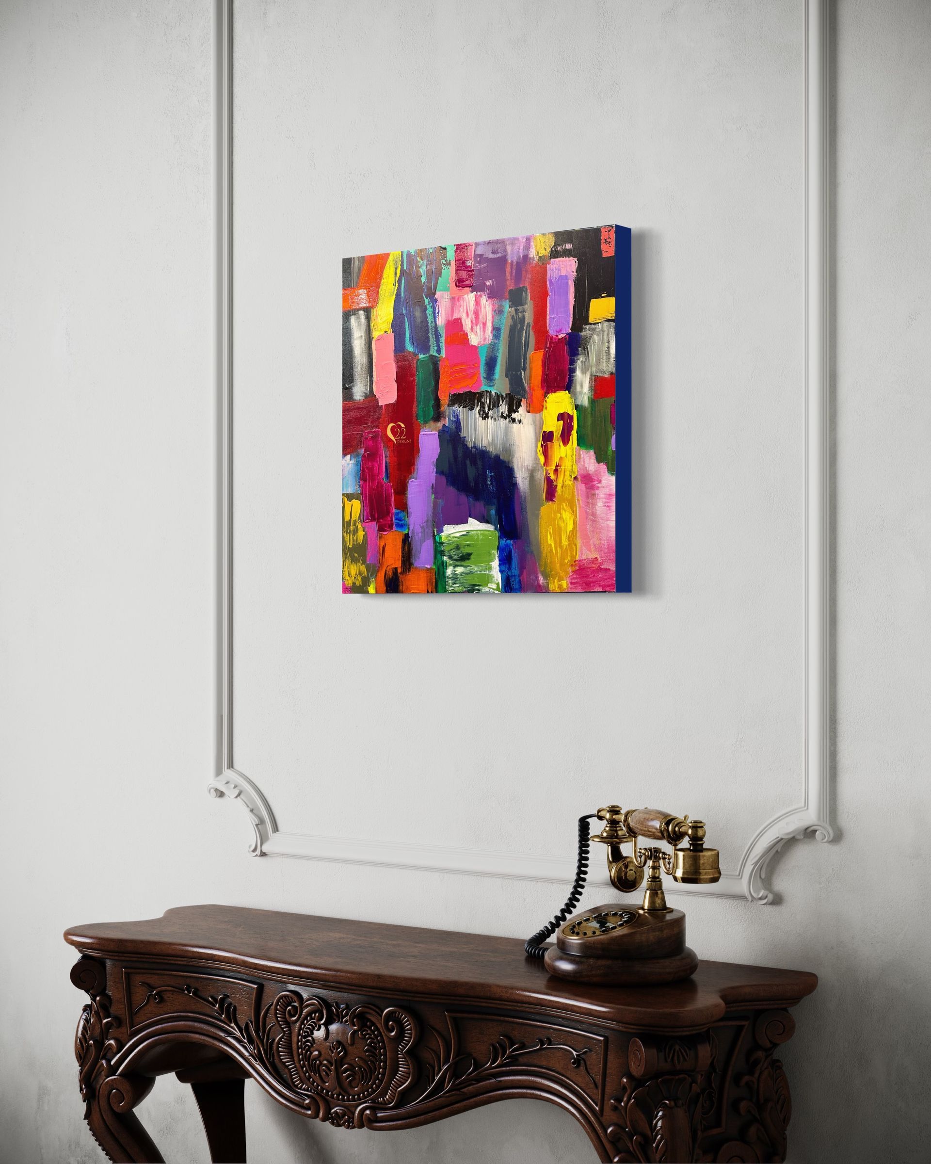 A colorful painting is hanging on a wall above a wooden table.