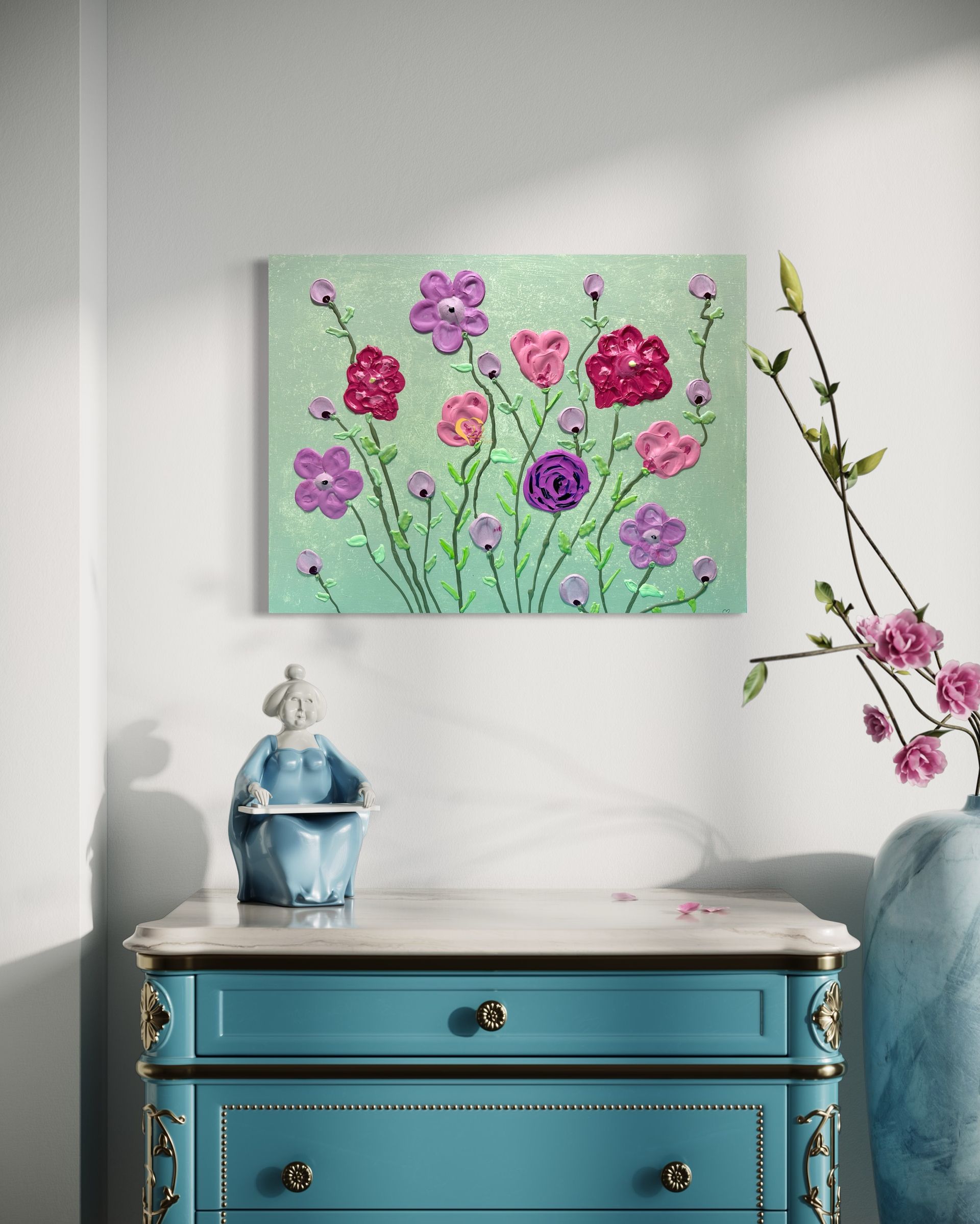 A painting of flowers is hanging on a wall above a blue dresser.