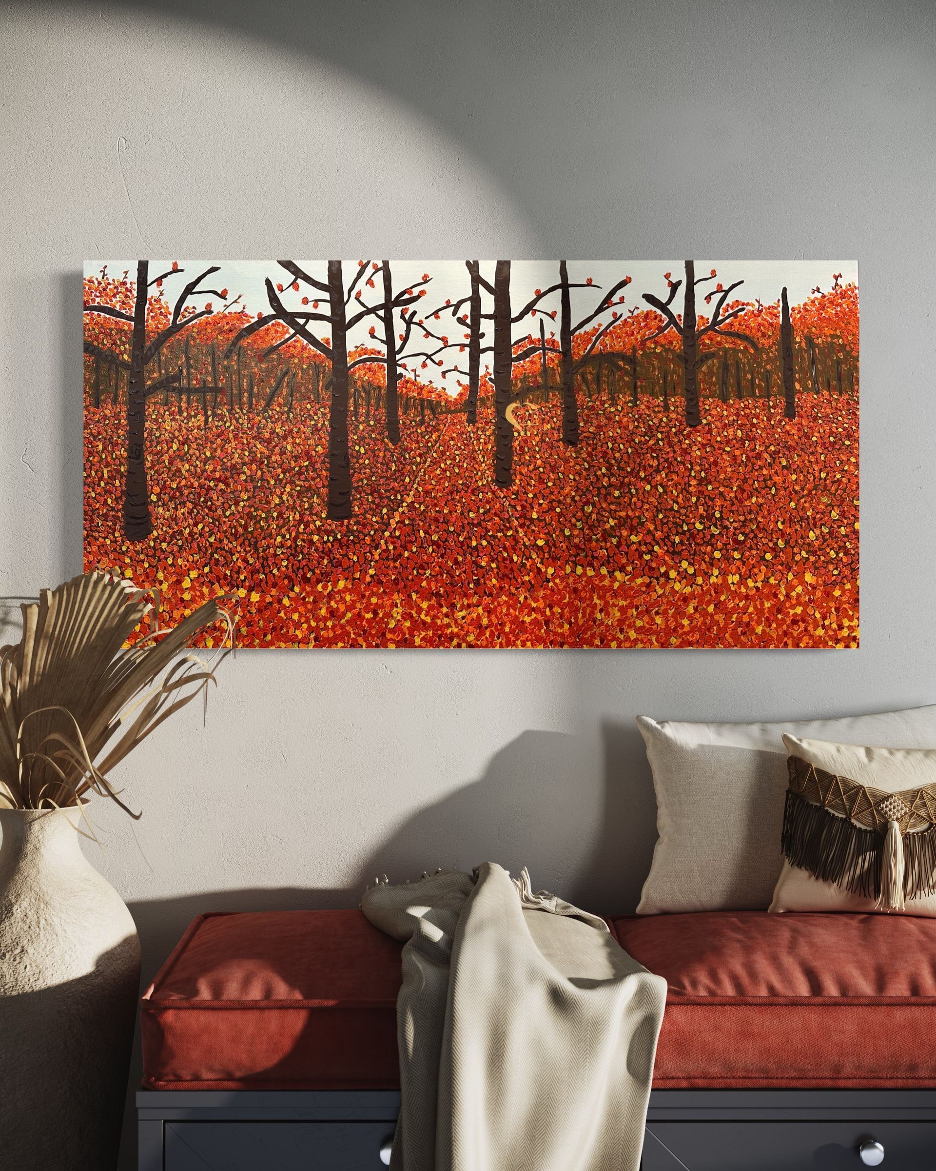 A living room with a couch and a painting on the wall