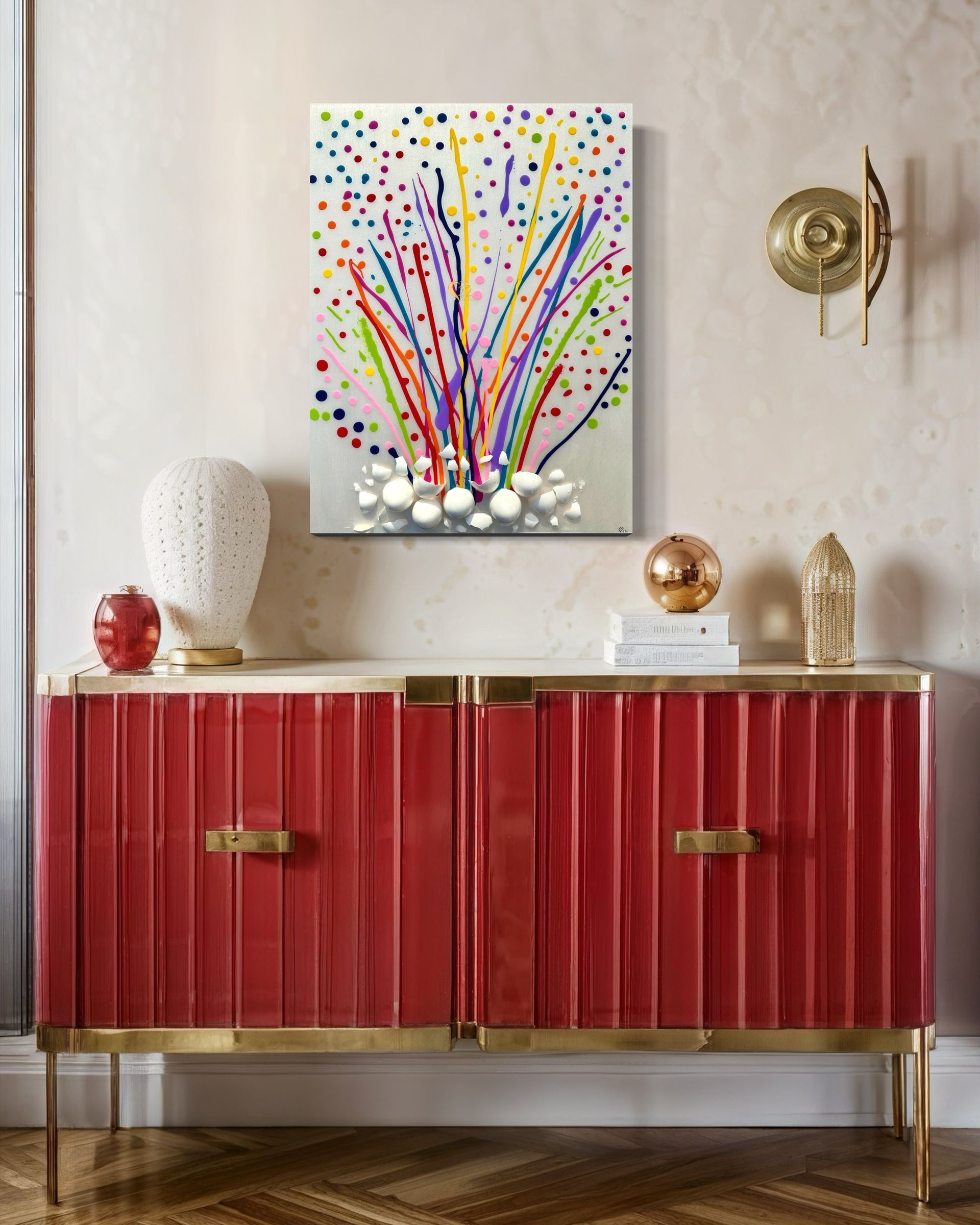 A red dresser with a painting on the wall above it.