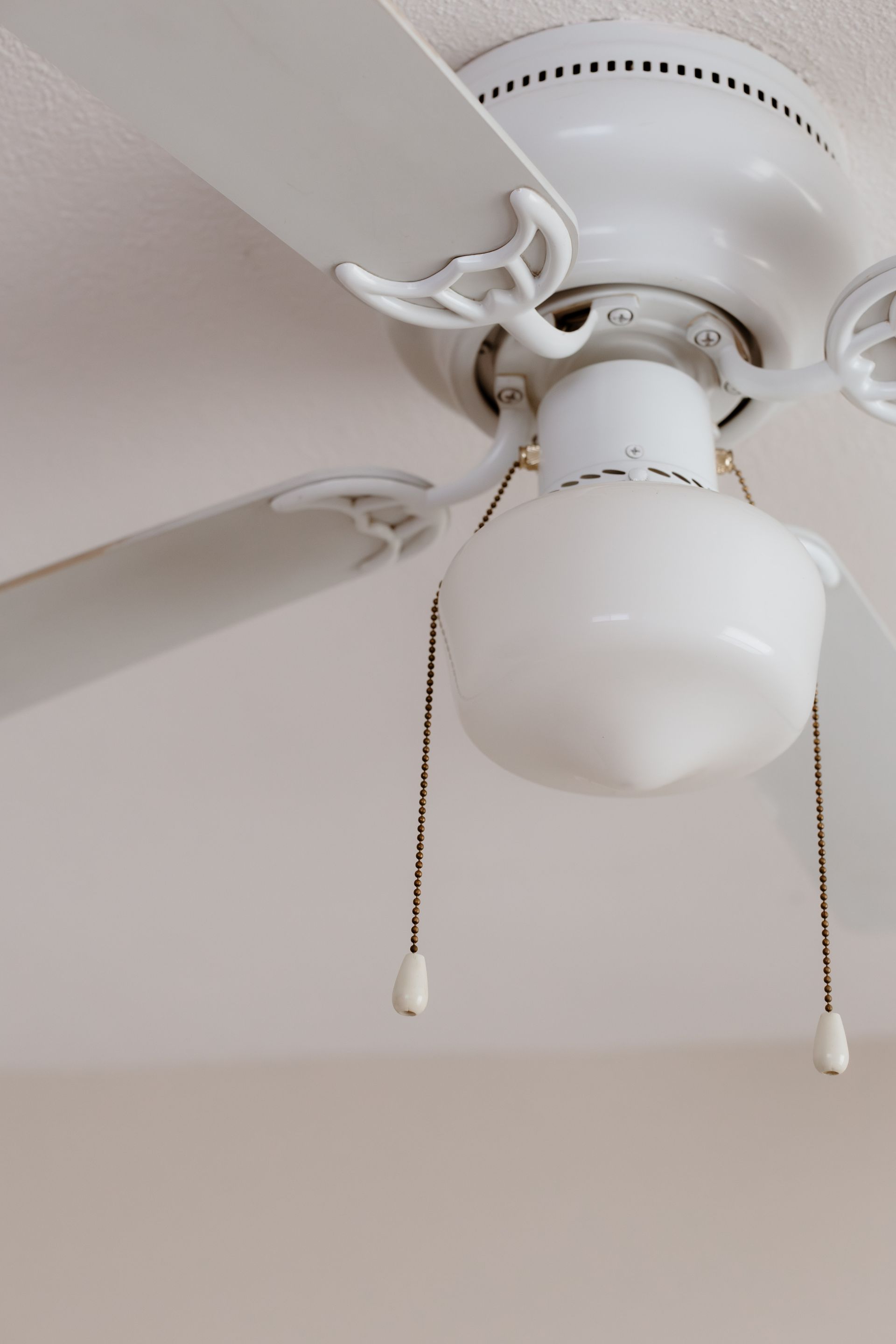 Ceiling fan with dangling pull chains. Apartment in South Minneapolis by RightMove Properties.