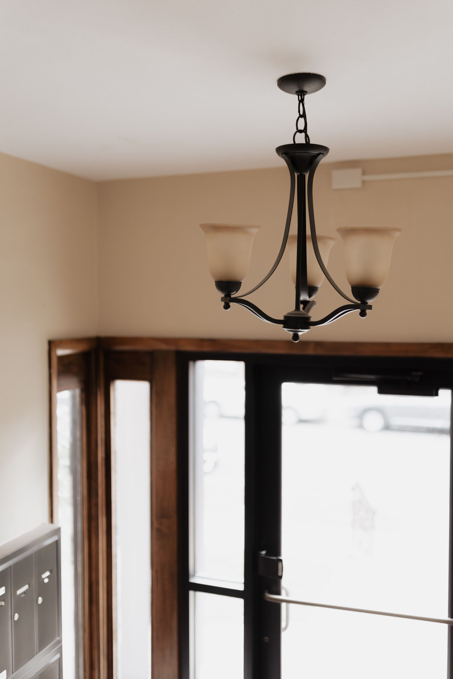 Chandelier overlooking an apartment entryway. Apartment in South Minneapolis by RightMove Properties.