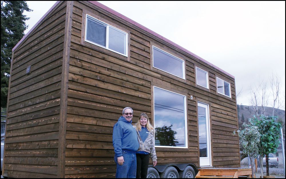 Wilder Construction team Keith Wilder and Daisy Pongrakthai stand next to the first tiny house Wilder built for the Hope Street Project. (Jamie Henneman photo)