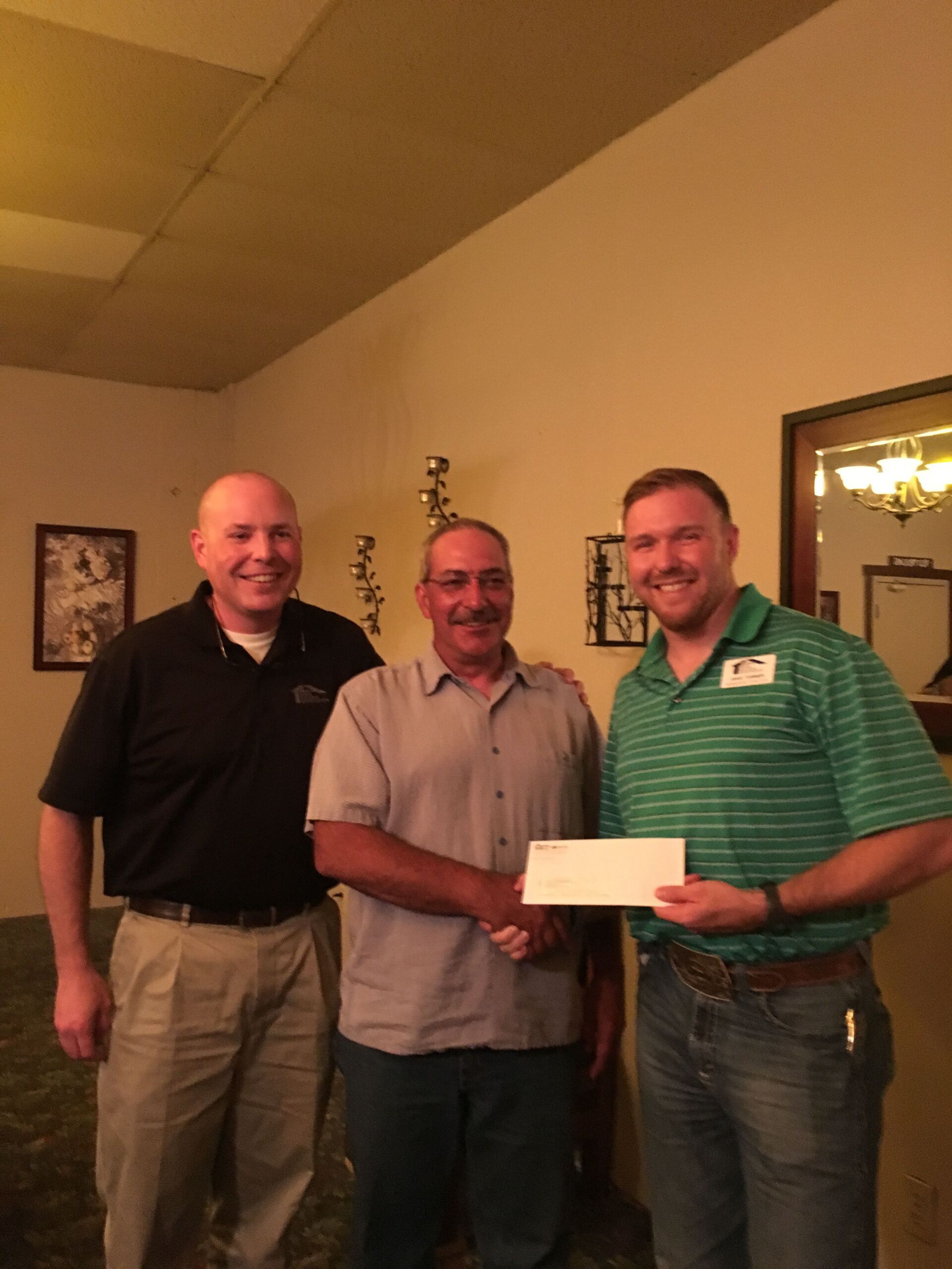 Keith Wilder (center), Tri-County Home Builders Association President, receives a check from Joel White (left), Executive Officer of SHBA and Jake Turner (right), Membership Director of SHBA