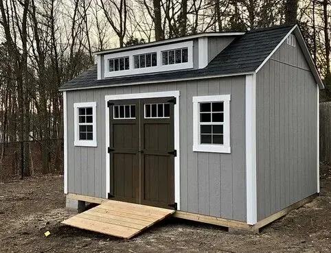 A shed with a ramp and a roof.