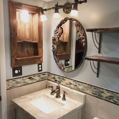 A bathroom with a sink , mirror and shelves.