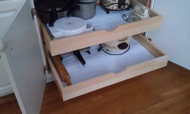 Pull-out kitchen cabinet with two wooden drawers. Contains small appliances like a mixer and slow cooker.