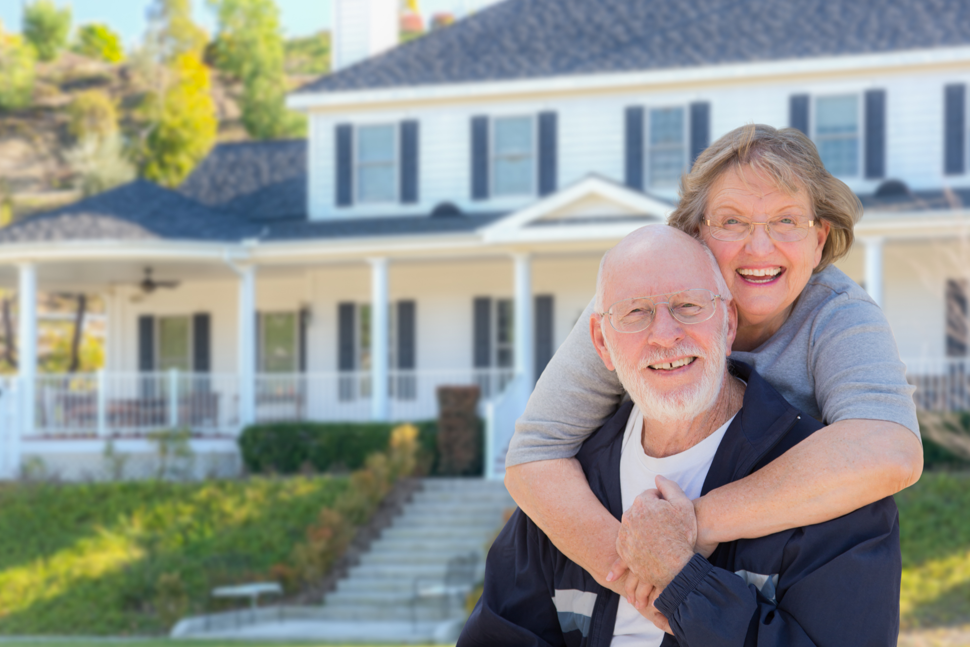 Real estate agent handing keys to a smiling couple after signing a contract.