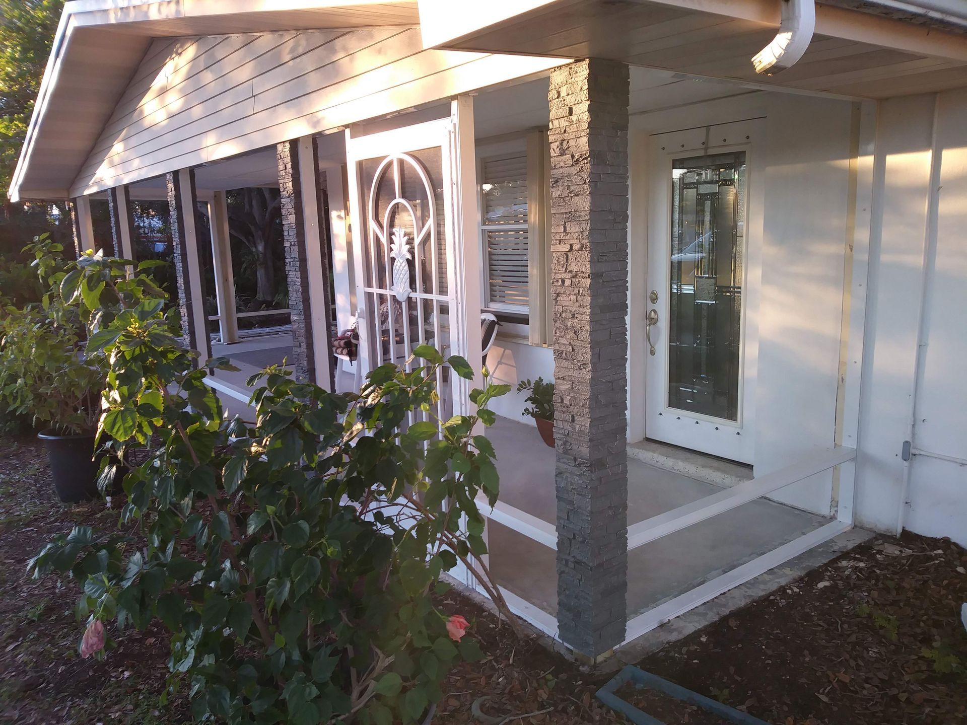 A white house with a porch and a door