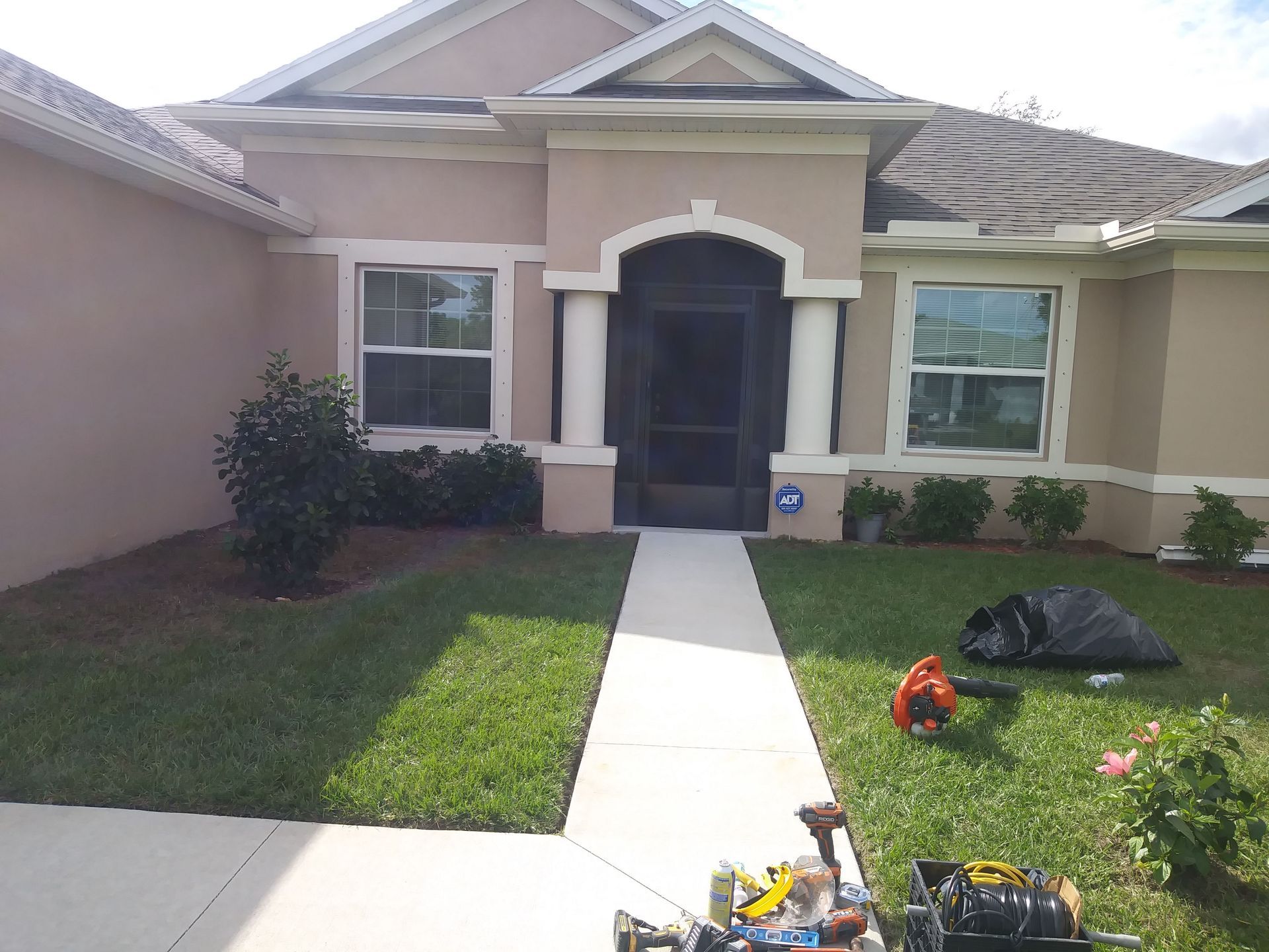 A house with a lawn mower in front of it