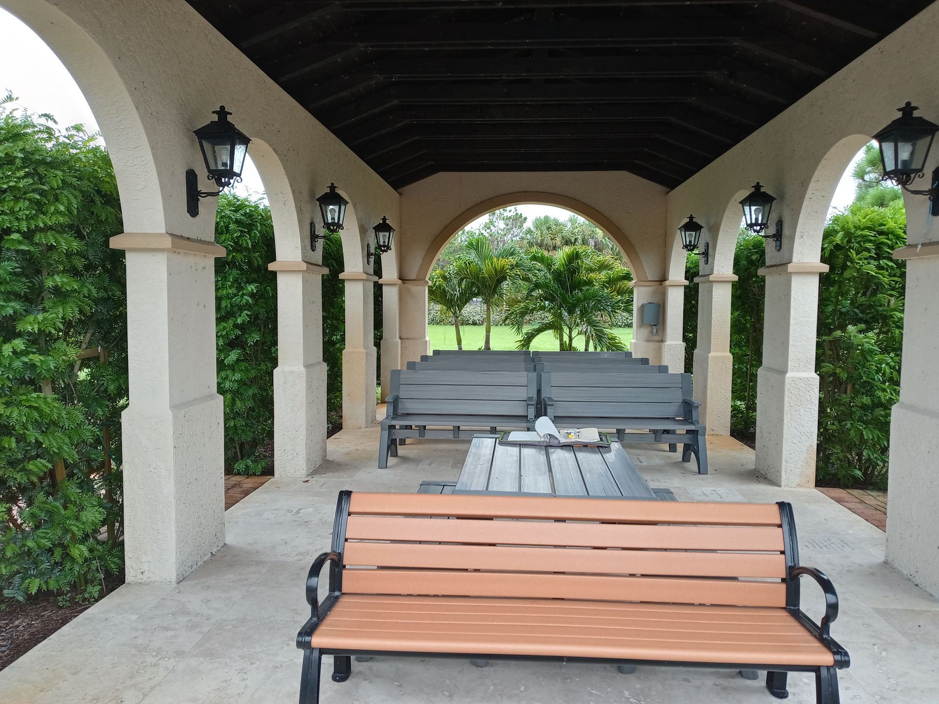 A gazebo with a bench and a table underneath it