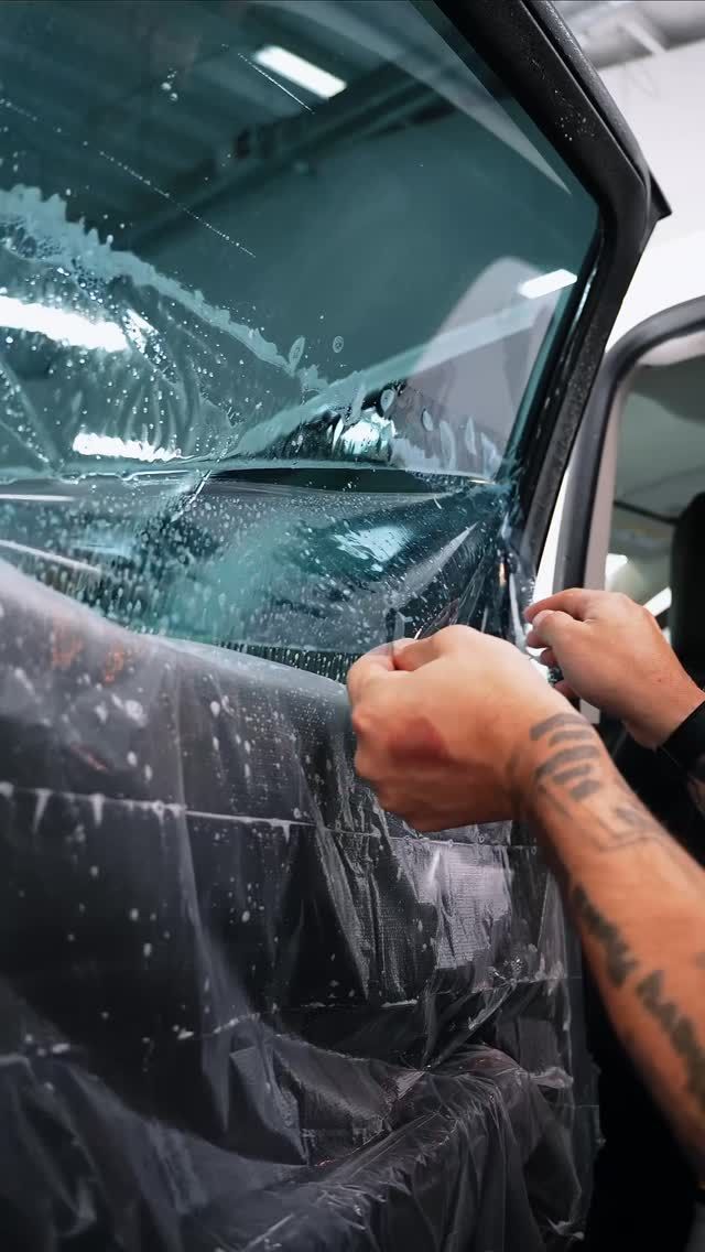 Blue Ferrari 812 Superfast in a garage, showcasing its front end and iconic logo.