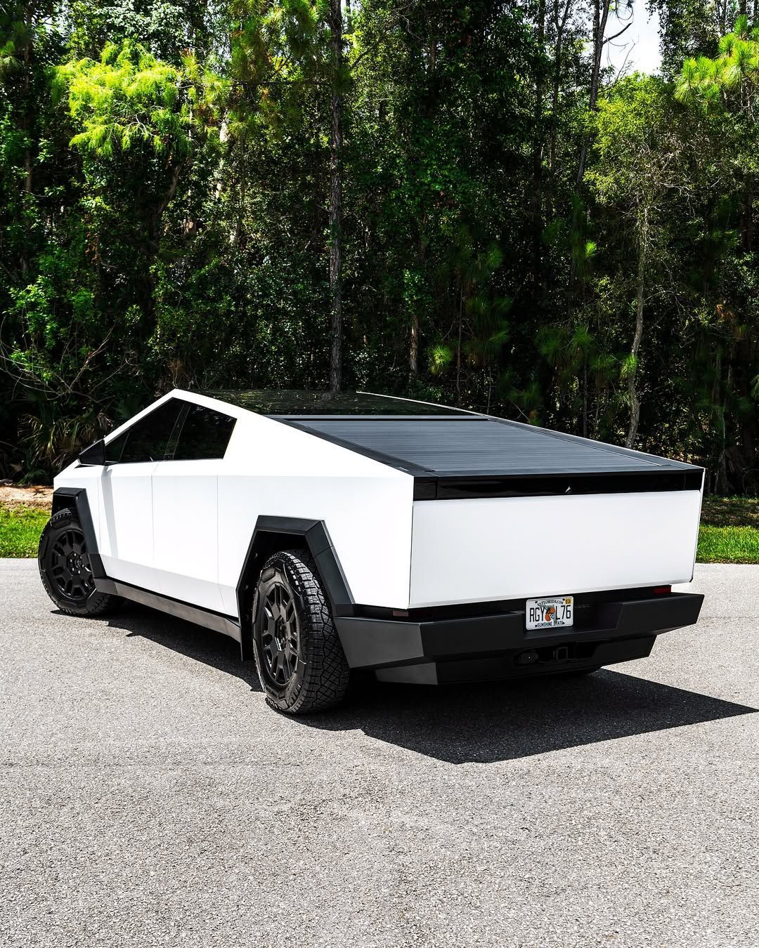 Blue Ferrari 812 Superfast in a garage, showcasing its front end and iconic logo.