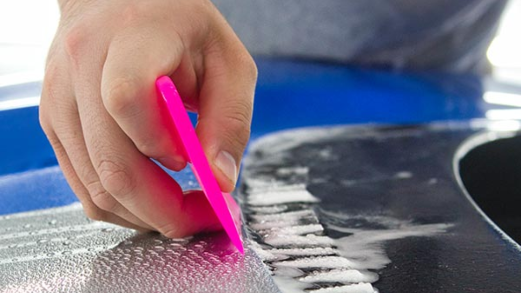 a professional applying ppf on a car