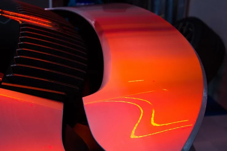 A close up of a circular object with red and orange lights on it.