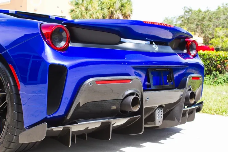 The rear end of a blue sports car is shown.