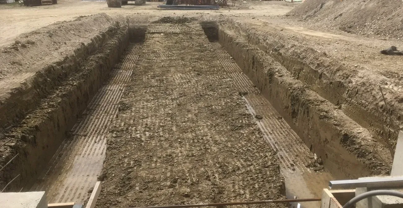 A large pile of dirt is sitting on top of a dirt field.