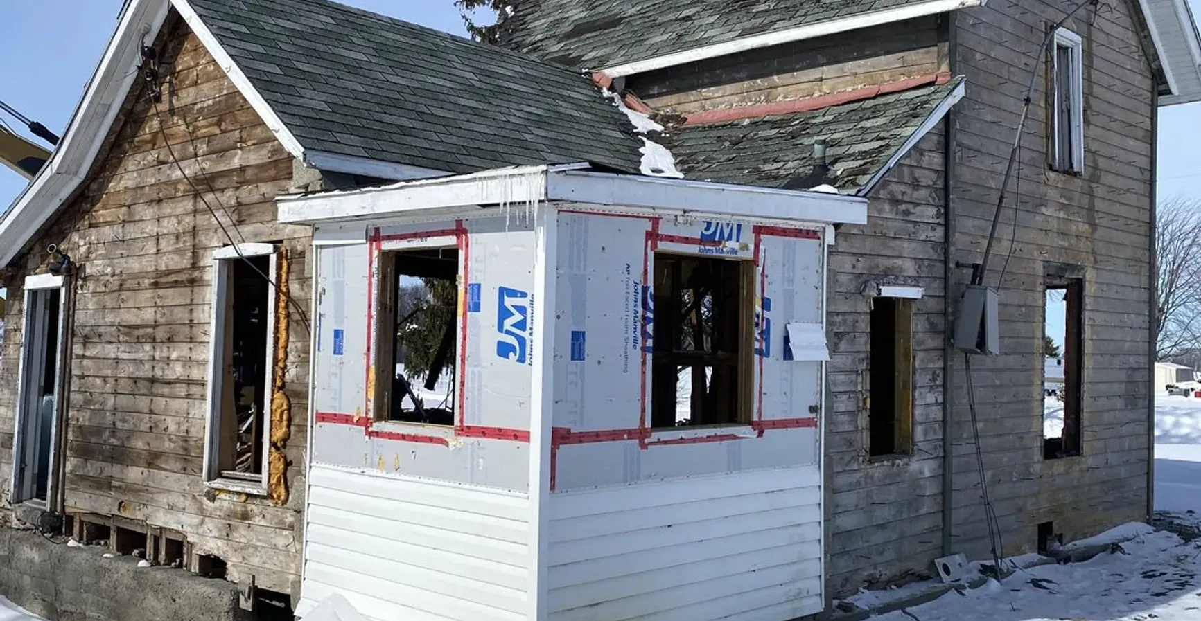 A house that is being remodeled and has a window that says ' lmt ' on it