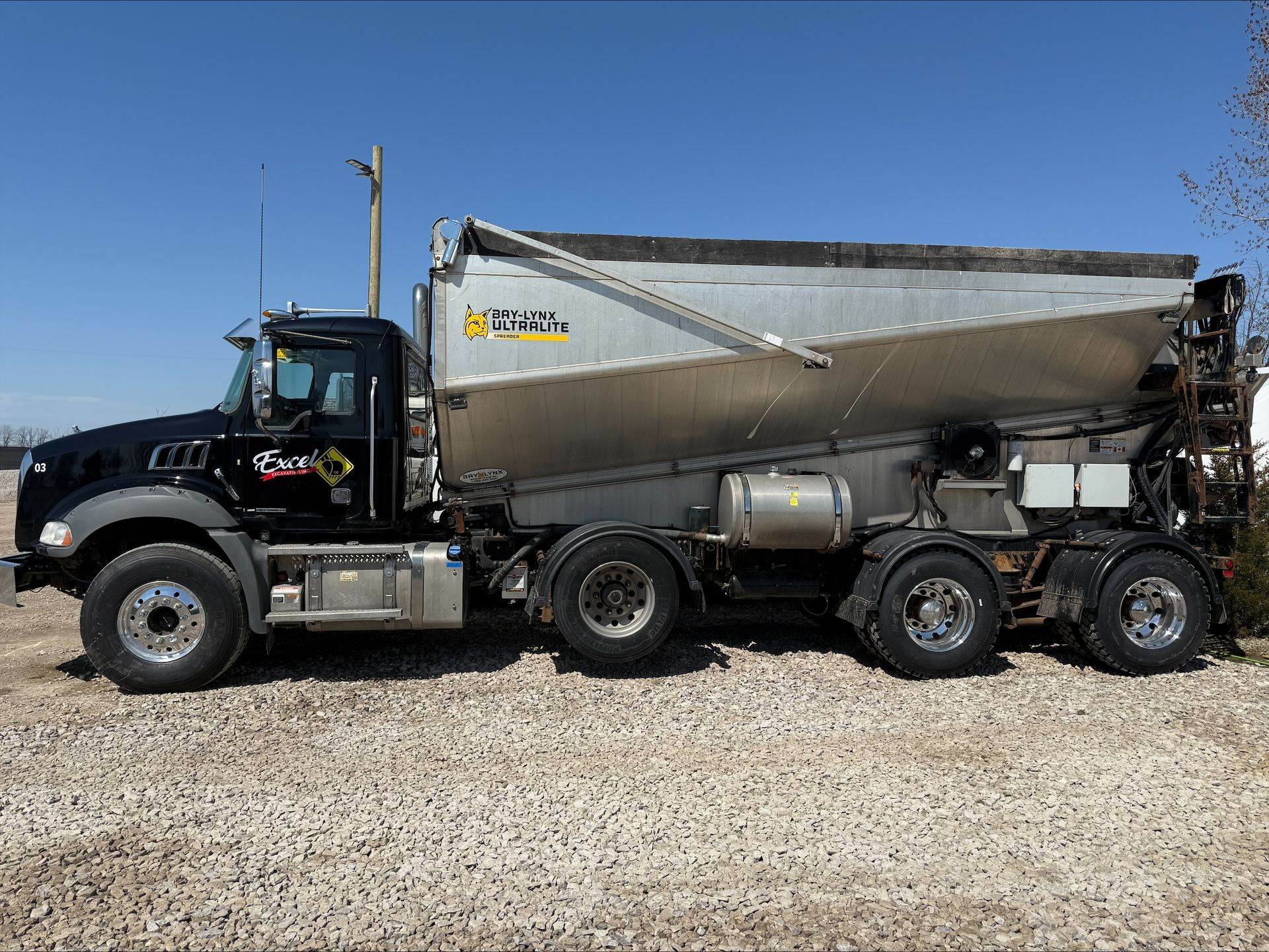 A construction site with a lot of pipes in the dirt.