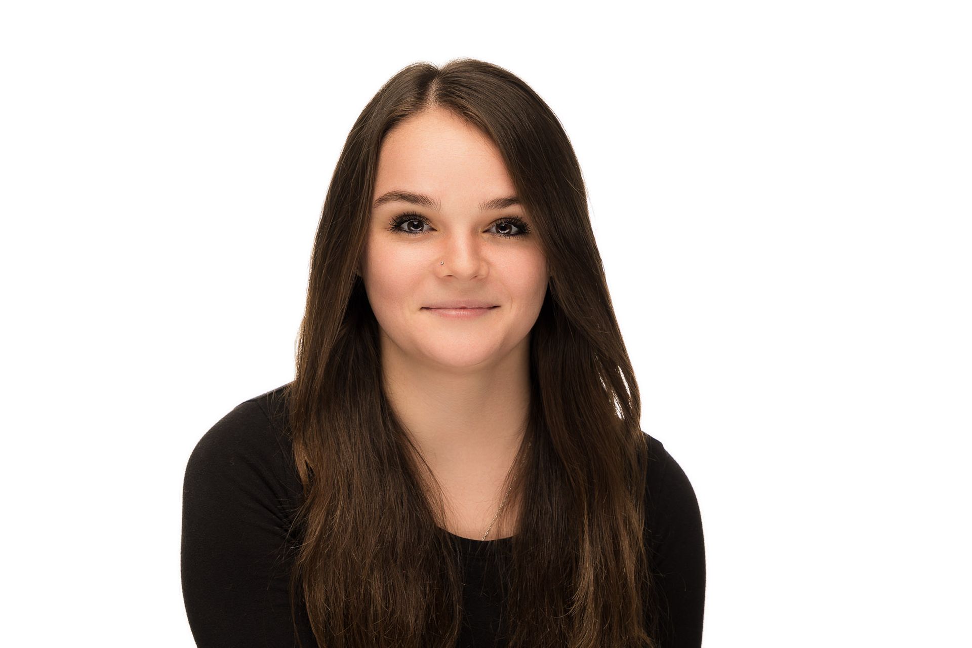 A young woman with long brown hair is wearing a black shirt and smiling.