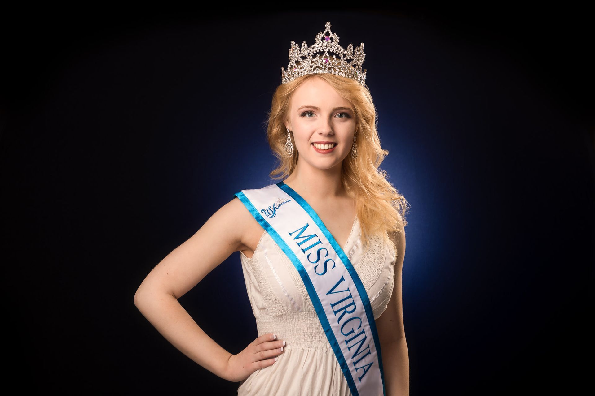 A woman is wearing a sash that says miss virginia