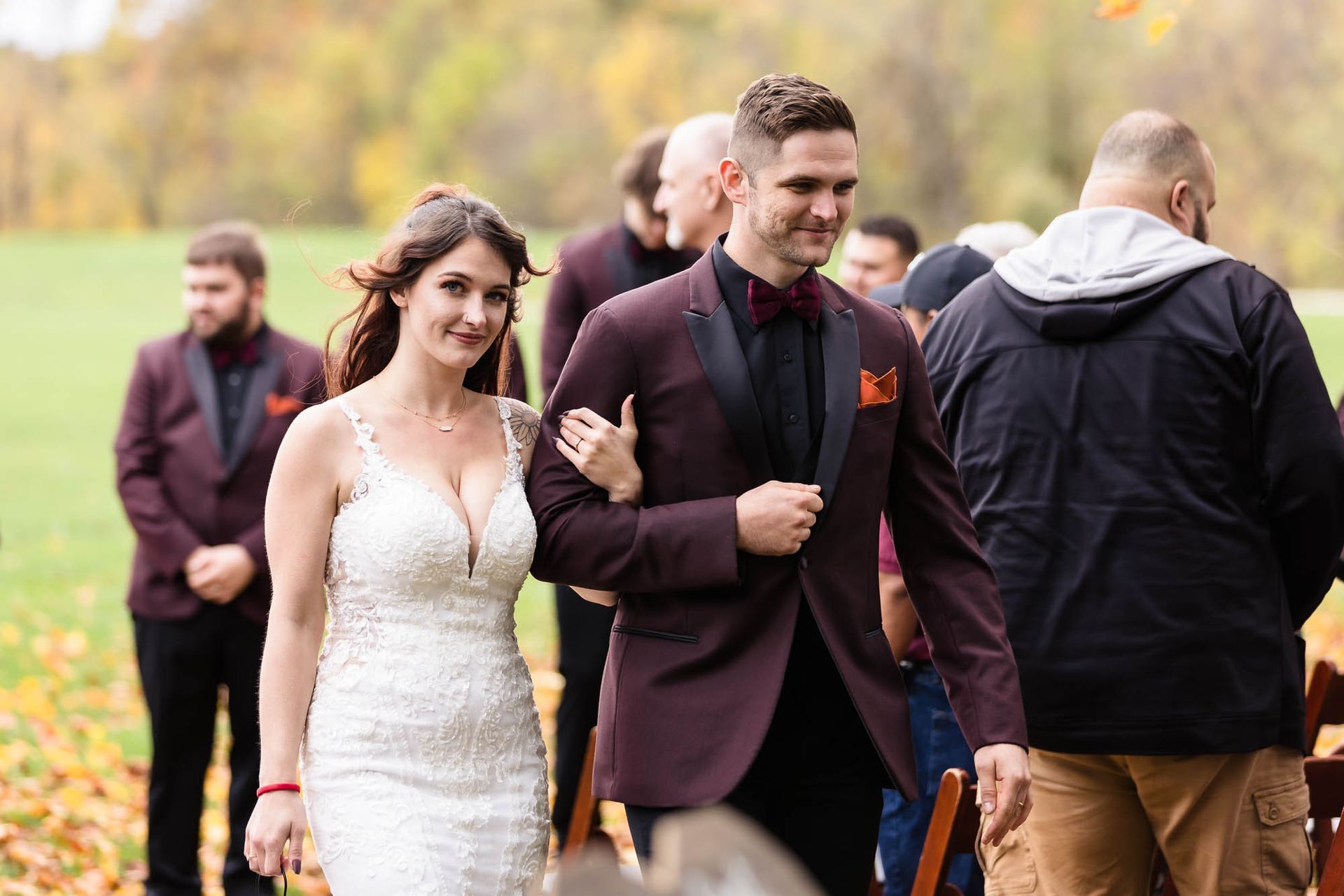 A bride and groom are walking down the aisle at their wedding.