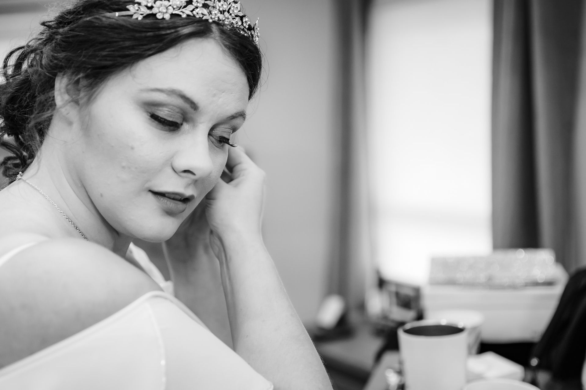 A black and white photo of a bride wearing a tiara.