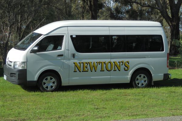 A white van with the word newton 's on the side